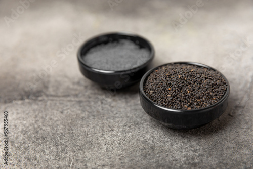 Basil seeds on textured wooden background. Close-up. Superfood. Ocimum basilicum. Organic basil seeds. selasih. Space for text. Copy space. photo