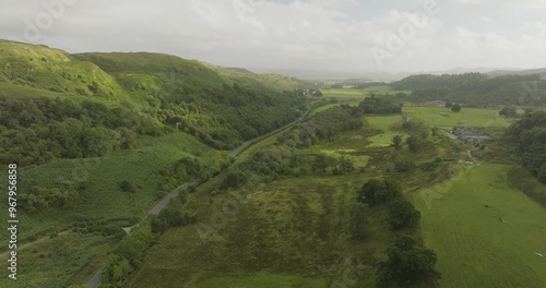 Aerial view of a picturesque green valley surrounded by rolling hills in the Scottish Highlands, Lochgilphead, United Kingdom. photo