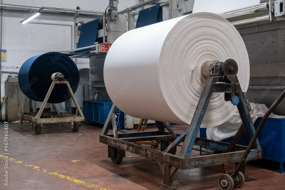 Fabric batching process machine industrial plant line in a textile factory. Fabric batching process machine industrial plant line in a textile factory.