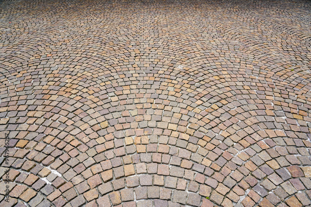 Fan-shaped pavement made of square natural granite cobble stones, pattern spreading out in fan form Fan-shaped pavement made of square natural granite cobble stones, pattern spreading out in fan form