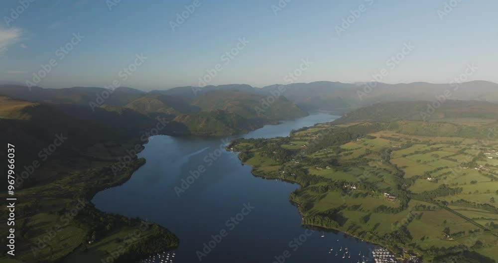 Aerial view of tranquil Ullswater lake surrounded by picturesque mountains and serene countryside, Penrith, England. Aerial view of tranquil Ullswater lake surrounded by picturesque mountains and serene countryside, Penrith, England.