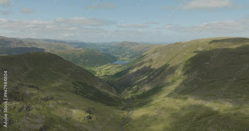 Aerial view of kirkstone pass with majestic mountains and a serene valley, Penrith, England. Aerial view of kirkstone pass with majestic mountains and a serene valley, Penrith, England.