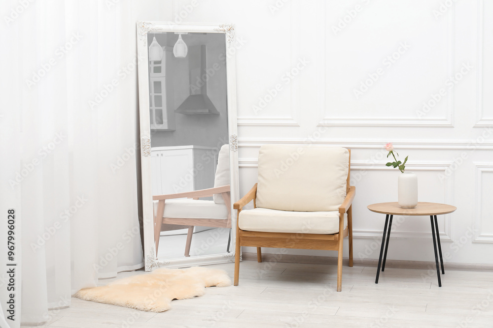 Large mirror near white wall in room. Interior design Large mirror near white wall in room. Interior design