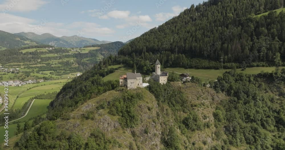 Aerial view of the picturesque CastelPietra castle surrounded by serene mountains and lush greenery, Freienfeld, Italy. Aerial view of the picturesque CastelPietra castle surrounded by serene mountains and lush greenery, Freienfeld, Italy.