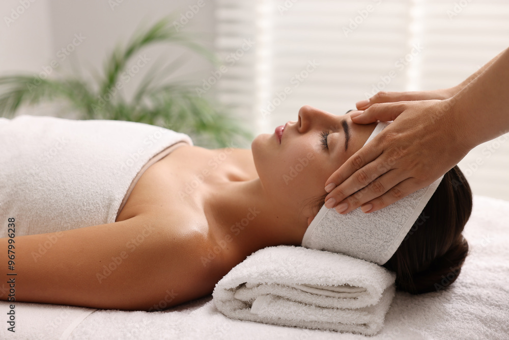 Attractive woman enjoying face massage in spa salon Attractive woman enjoying face massage in spa salon