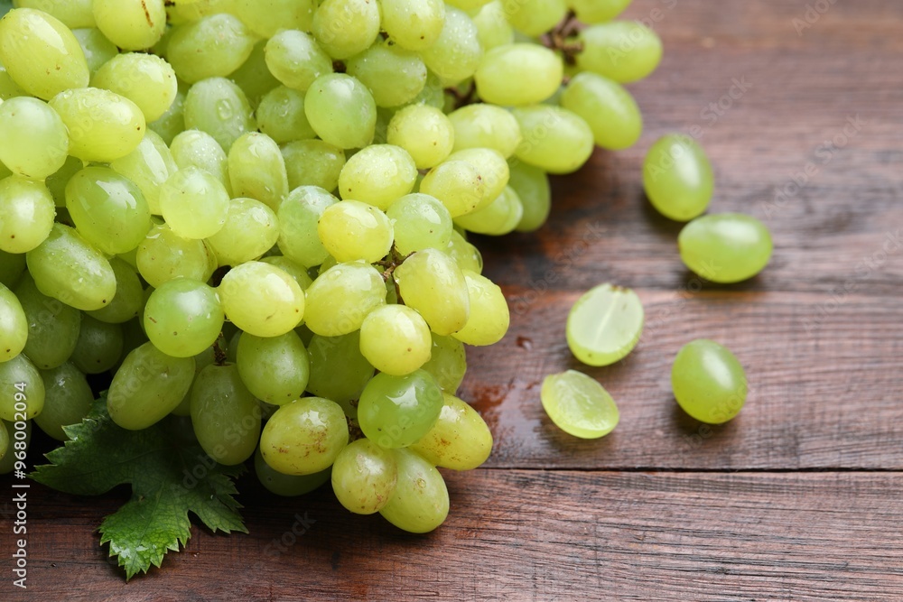 Fresh ripe grapes on wooden table, closeup Fresh ripe grapes on wooden table, closeup