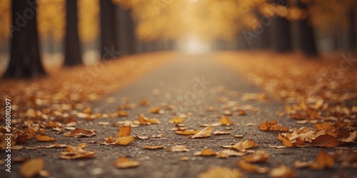 Autumn Pathway Covered with Fallen Leaves Featuring Soft Lighting and a Blurry Foreground Symbolizing the Peacefulness and Tranquility of Fall.