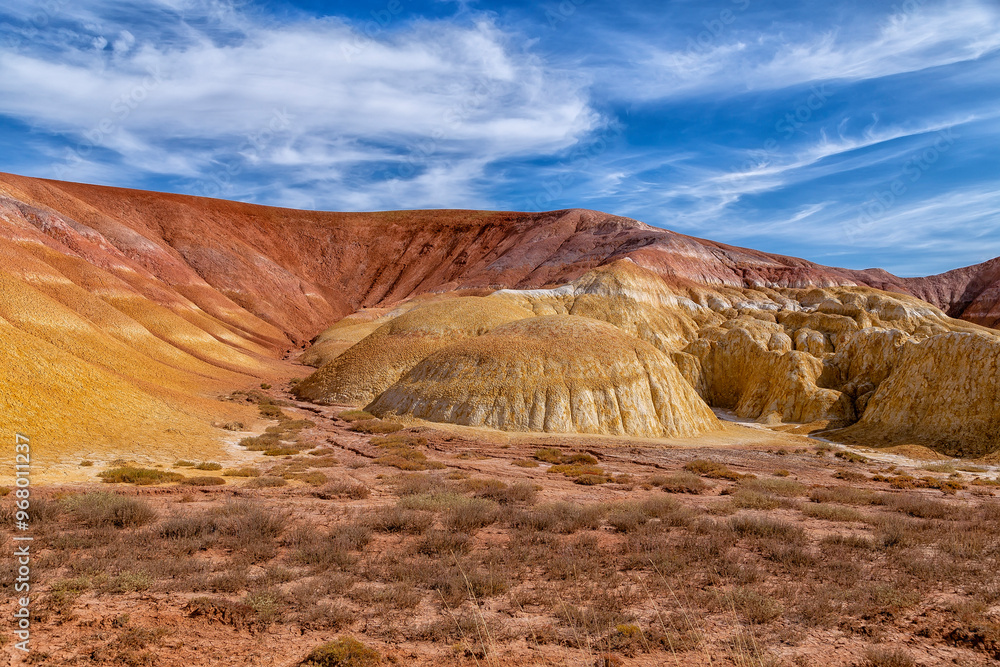 Akzhar Ulytau chalk mountains in the desert of Kazakhstan. Rare sandy hills with many multi-colored layers of clay, sand, chalk and gravel of bizarre shape far from civilization with sparse vegetation
