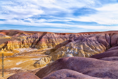 Akzhar Ulytau chalk mountains in the desert of Kazakhstan. Rare sandy hills with many multi-colored layers of clay, sand, chalk and gravel of bizarre shape far from civilization with sparse vegetation photo