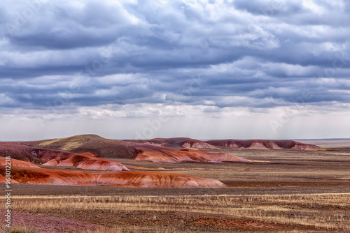 Akzhar Ulytau chalk mountains in the desert of Kazakhstan. Rare sandy hills with many multi-colored layers of clay, sand, chalk and gravel of bizarre shape far from civilization with sparse vegetation