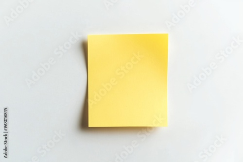 Handwritten reminder on a yellow sticky note placed on a clean white background