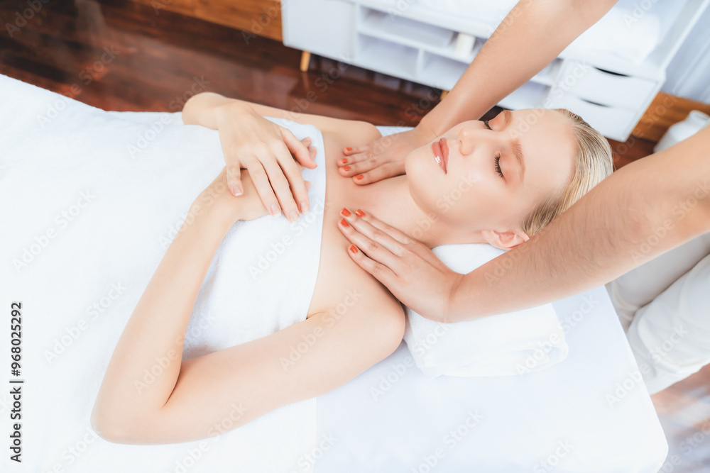 Caucasian woman customer enjoying relaxing anti-stress spa massage and pampering with beauty skin recreation leisure in day light ambient salon spa at luxury resort or hotel. Quiescent Caucasian woman customer enjoying relaxing anti-stress spa massage and pampering with beauty skin recreation leisure in day light ambient salon spa at luxury resort or hotel. Quiescent