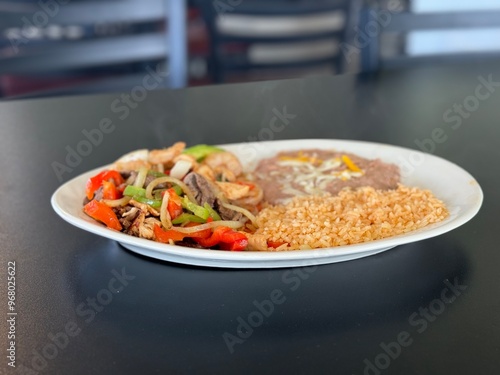 Mexican Chicken Fajitas with Rice and Beans on Table photo