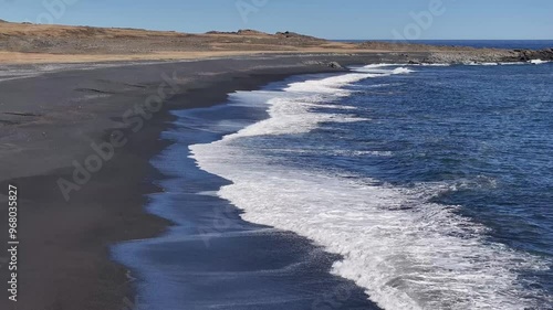 Aerial view of the tranquil black sand beach and rugged coastline with waves crashing, Hvalnesviti Sea View Point, Iceland. photo