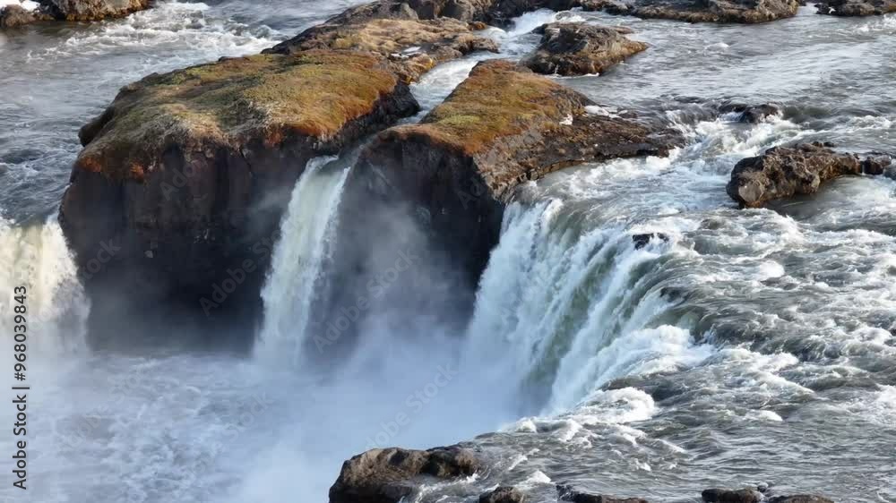 Aerial view of the majestic Godafoss waterfall cascading over rugged rocks in the Northern Region, Iceland.