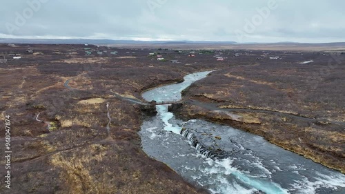 Aerial view of Bruararfoss waterfall flowing through a serene landscape, Southern region, Iceland. photo