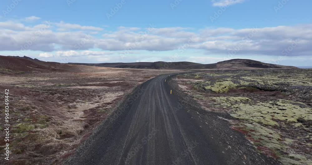 Aerial view of barren high plateau with winding road under a beautiful blue sky, Reykjavik, Iceland. Aerial view of barren high plateau with winding road under a beautiful blue sky, Reykjavik, Iceland.