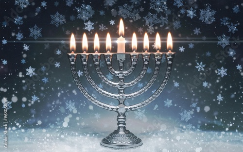 Hanukkah Candles in a Window with Snow Falling Outside photo