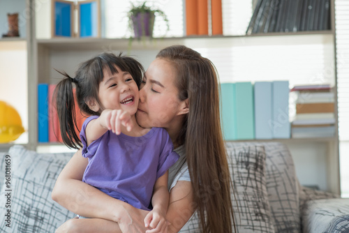 Mother having fun and playing with her daughter at home, family concept