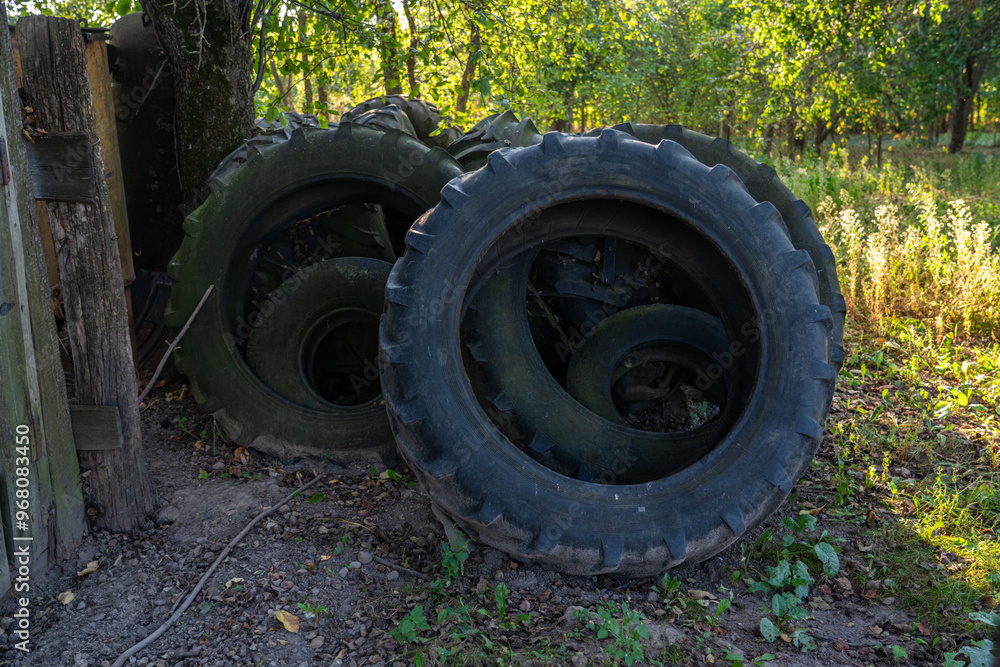 Old tires of tractors and trucks. A bunch of old tires in the village Old tires of tractors and trucks. A bunch of old tires in the village