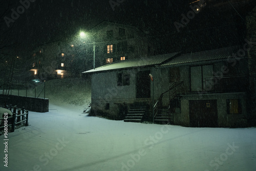 Canvas Print Moody evening night in the city during a snowfall on New Years Eve, Aprica, Nort