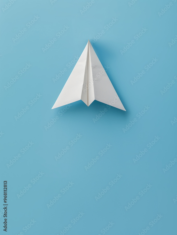White paper airplane on a light blue background White paper airplane on a light blue background