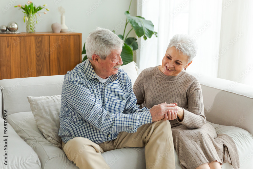 Senior adult mature couple in love holding hands at home. Mid age old husband and wife looking with tenderness love enjoying wellbeing. Grandmother grandfather together. Family moment love and care Senior adult mature couple in love holding hands at home. Mid age old husband and wife looking with tenderness love enjoying wellbeing. Grandmother grandfather together. Family moment love and care