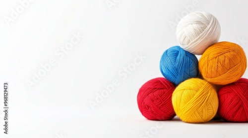 A collection of colorful yarn balls in various shades of red, blue, yellow, orange and white, arranged in a pyramid shape, perfect for crafting and creating unique knitted or crocheted projects.