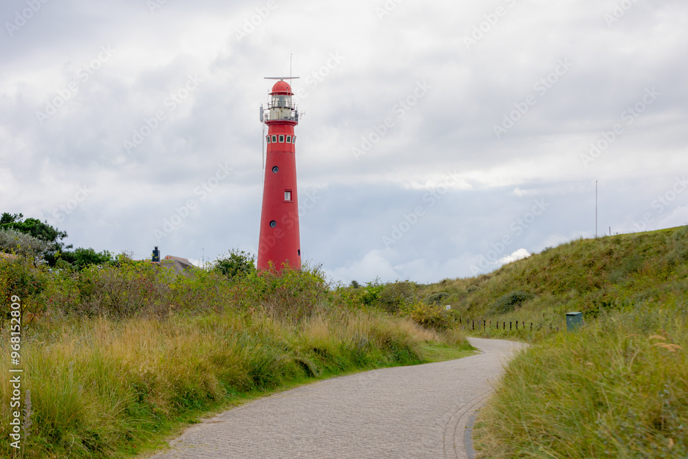 The red lighthouse north tower (Noordertoren) and path, Schiermonnikoog is a municipality and national park in the Northern Netherlands and one of the West Frisian Islands on the edge of the North Sea The red lighthouse north tower (Noordertoren) and path, Schiermonnikoog is a municipality and national park in the Northern Netherlands and one of the West Frisian Islands on the edge of the North Sea