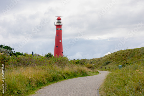 The red lighthouse north tower (Noordertoren) and path, Schiermonnikoog is a municipality and national park in the Northern Netherlands and one of the West Frisian Islands on the edge of the North Sea photo