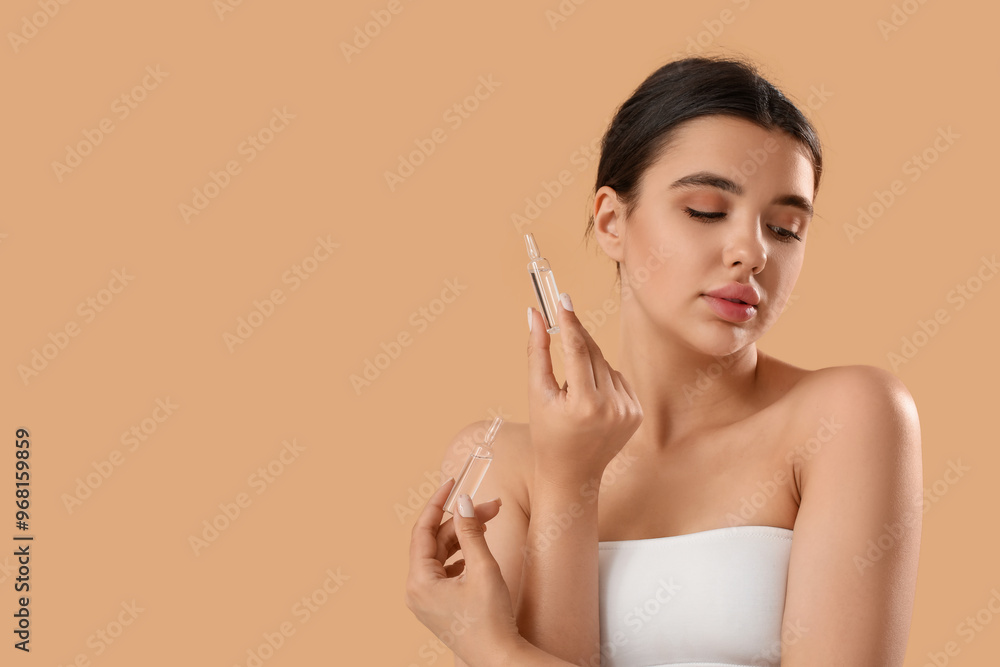 Beautiful young woman with ampules on beige background Beautiful young woman with ampules on beige background