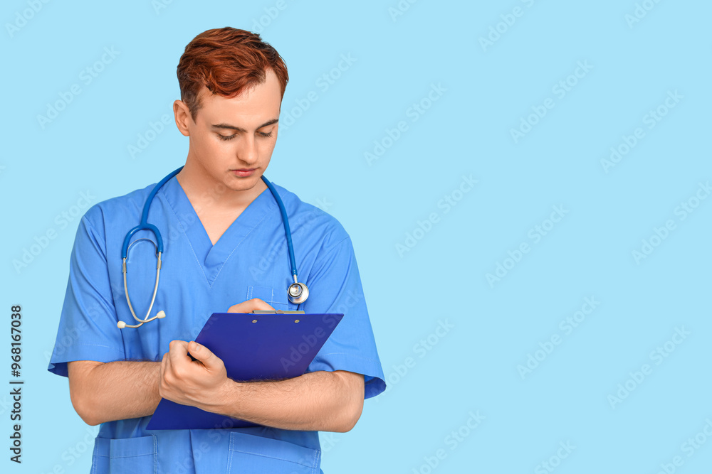 Male medical student with clipboard on blue background Male medical student with clipboard on blue background
