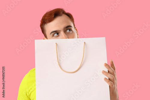 Young man with shopping bag...