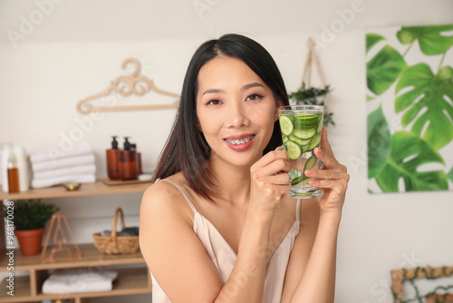 Young Asian woman with glas...
