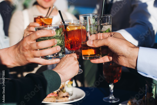 Canvas Print Group of guests celebrate and raise glasses, cheering with alcohol glasses with