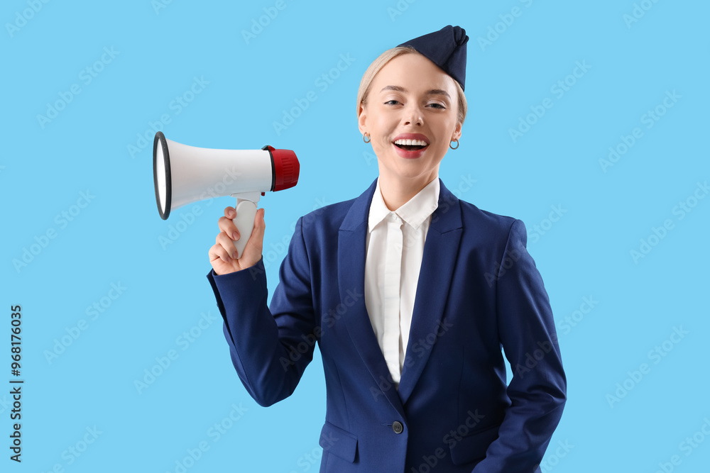 Young stewardess with megaphone on blue background Young stewardess with megaphone on blue background