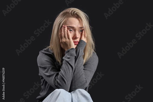 Depressed young woman on da...
