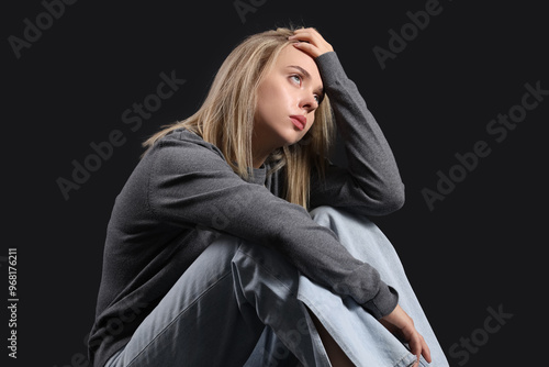 Depressed young woman sitti...