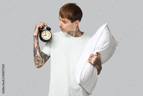 Tattooed young man in pajam...