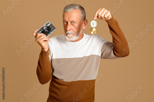 Senior man with compass and...