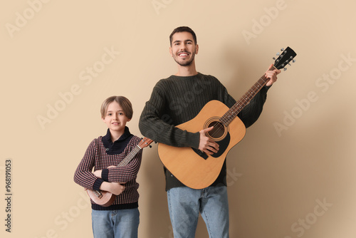 Smiling father and son play...