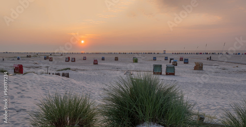 Stimmungsvoller Sonnenuntergang auf der Insel Amrum mit Dünen und Meer photo