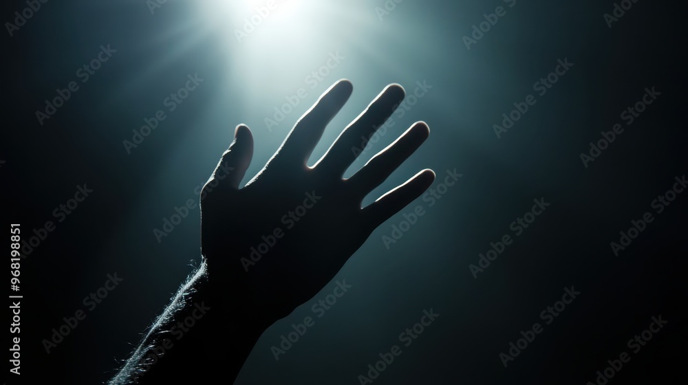 Silhouette of a hand reaching towards a bright light source in a dark atmosphere, symbolizing hope, aspiration, and reaching for the unknown. Silhouette of a hand reaching towards a bright light source in a dark atmosphere, symbolizing hope, aspiration, and reaching for the unknown.