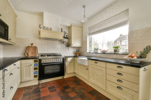 Bright and cozy modern kitchen interior with terracotta tiles photo