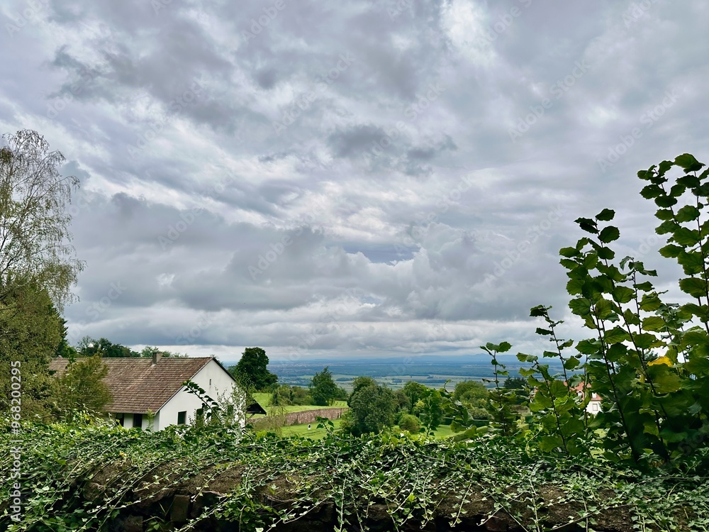 Panoramic View of Alsace Plain from Former Marbach Abbey in Obermorschwihr, Overlooking Eguisheim and Voegtlinshoffen on the Famous Wine Route in Haut-Rhin, Grand Est, France Panoramic View of Alsace Plain from Former Marbach Abbey in Obermorschwihr, Overlooking Eguisheim and Voegtlinshoffen on the Famous Wine Route in Haut-Rhin, Grand Est, France