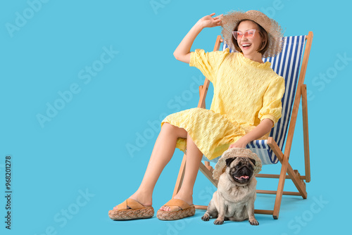 Young woman with cute pug d...