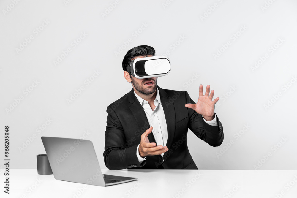 Professional project manager looking by using VR goggle while sitting at laptop. Skilled business man wearing visual reality headset while connecting metaverse or visual world. Innovation. Deviation.