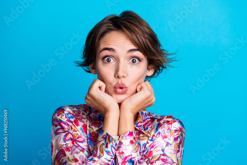 Photo of funny lovely cute girl pouted lips wear stylish print clothes arms touch face isolated on blue color background