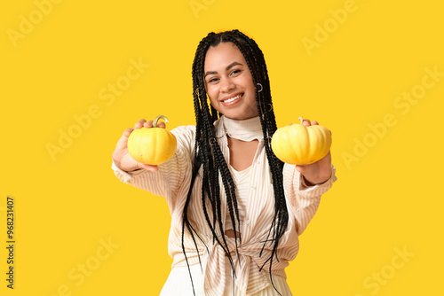Smiling young woman holding...