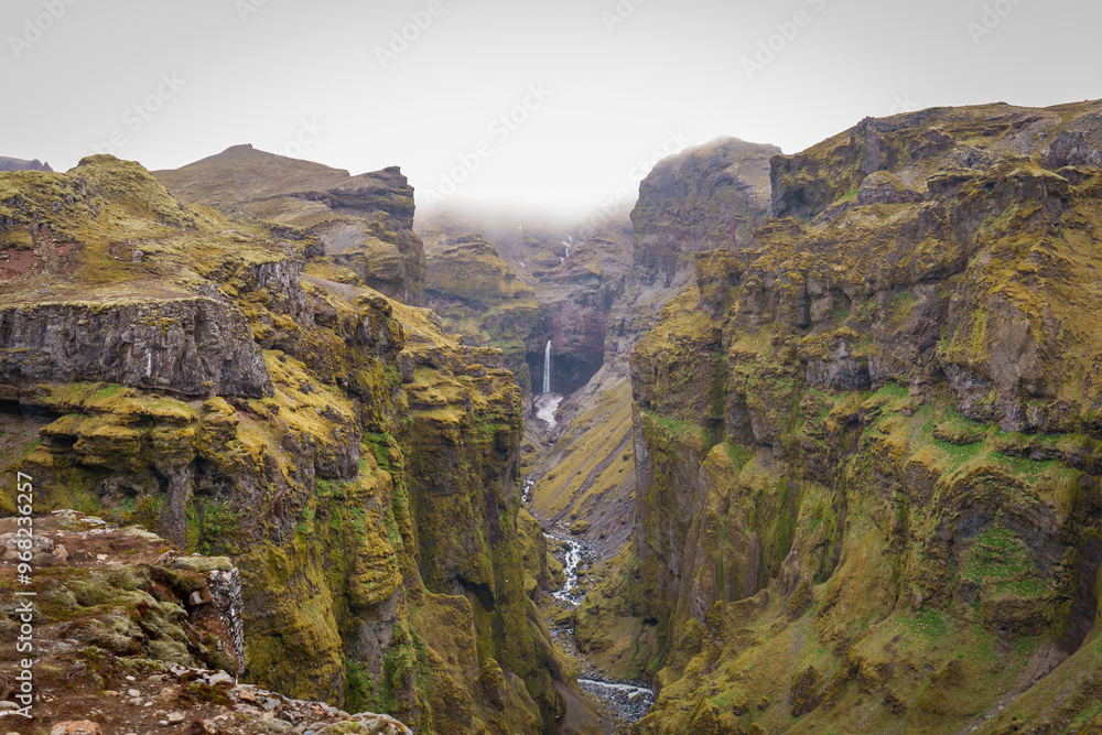 Stunning mountains with cascading waterfalls flowing through the lush Múlagljúfur Canyon in Iceland's rugged landscape Stunning mountains with cascading waterfalls flowing through the lush Múlagljúfur Canyon in Iceland's rugged landscape